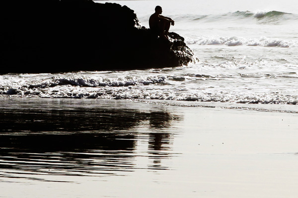 person meditating on rocks