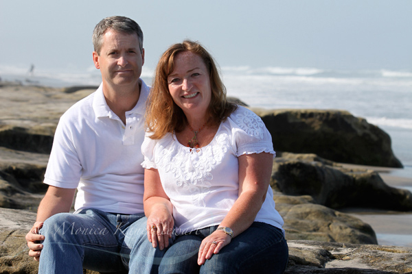 portrait of couple on rocks at beach